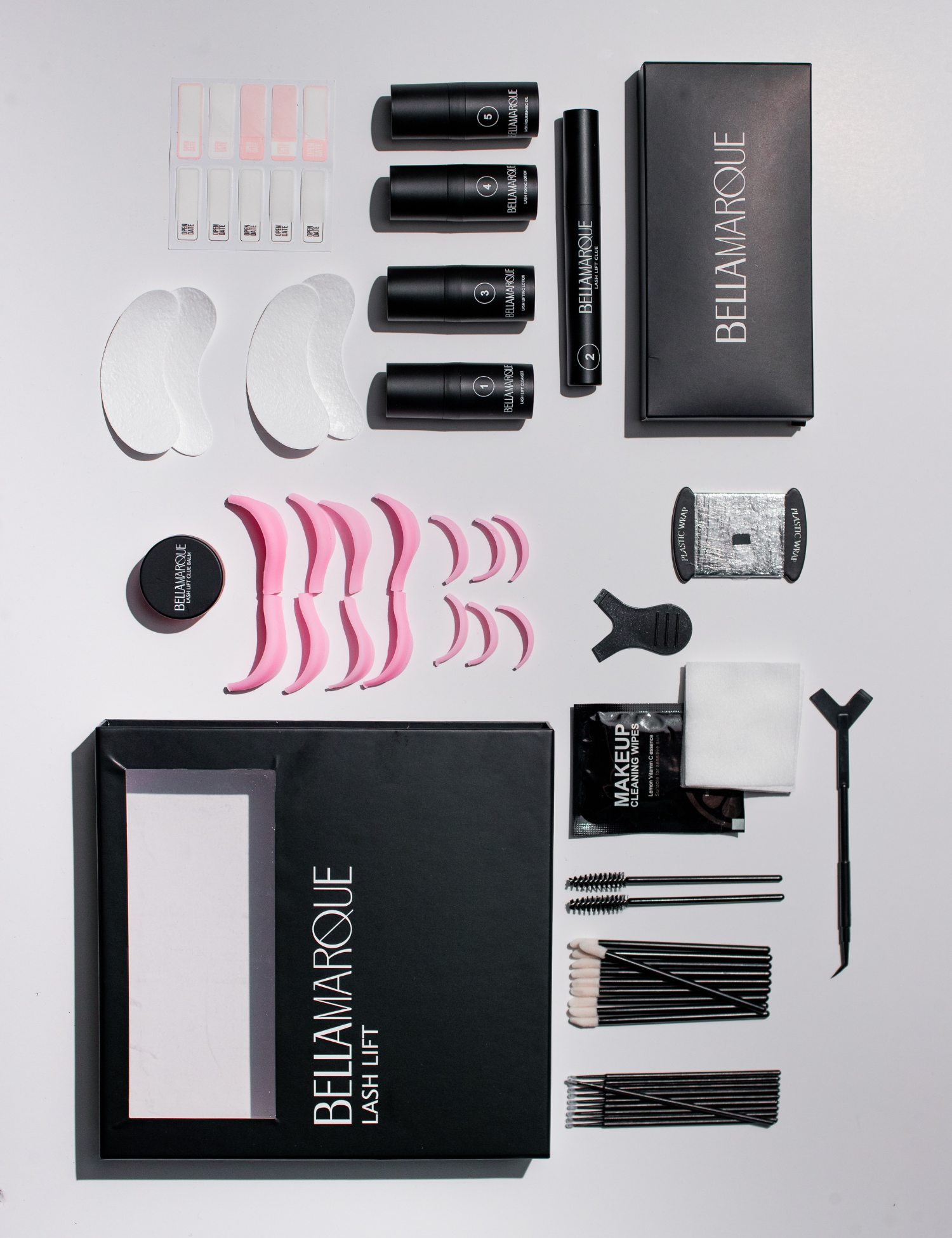 Top view of BELLAMARQUE Lash Lift kit box open with multiple lash treatment components laid out.