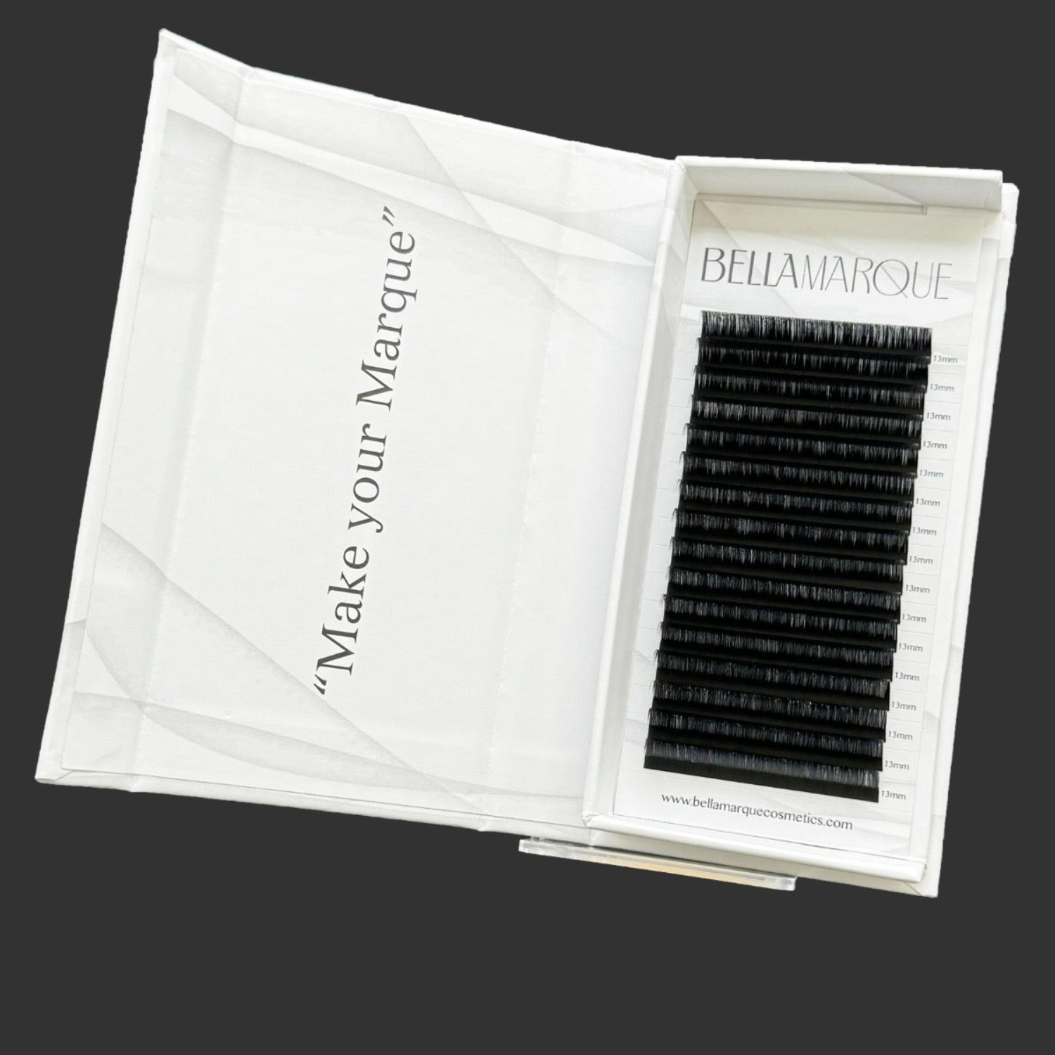Open white lash extension tray displaying neatly organized black lashes, with a clear protective lid and 'Make your Marque' printed in elegant script on the packaging.